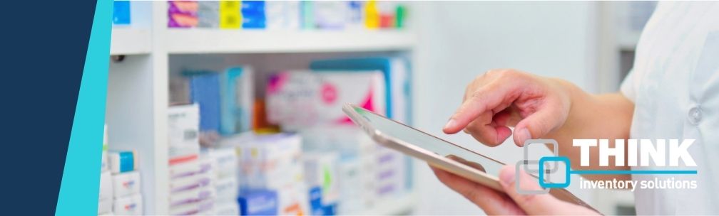 PHARMACEUTICAL DISTRIBUTOR CHALLENGE A person stands in front of medicines and tablets on shelving, and checks a computer table