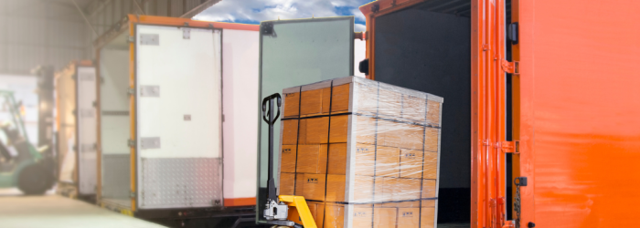 Lorries lined up with their back doors open, forklift trucks full of packaged stock filling the lorries up