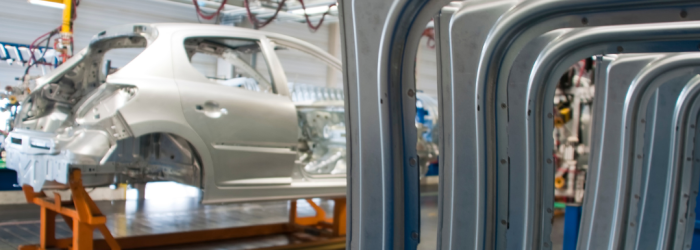 The shell of a car on a factory production line waiting to be built