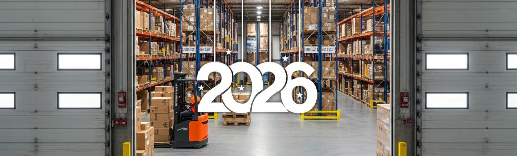The year 2026 over the top of an image of a warehouse door open, looking into the warehouse with shelving and stock