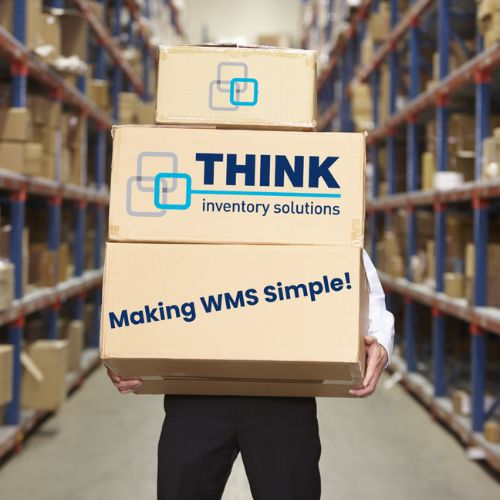Warehouse worker holding cardboard boxes which say 'THINK Inventory Solutions, making WMS simple'