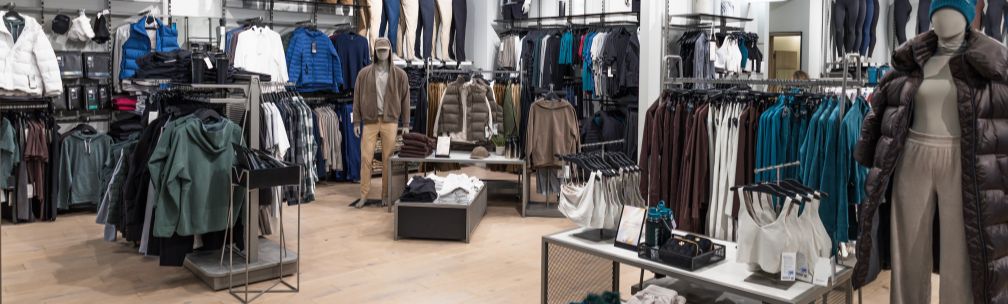 A retail store with lots of clothing on hangers