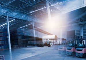 Delivery vehicle and forklift trucks inside a warehouse